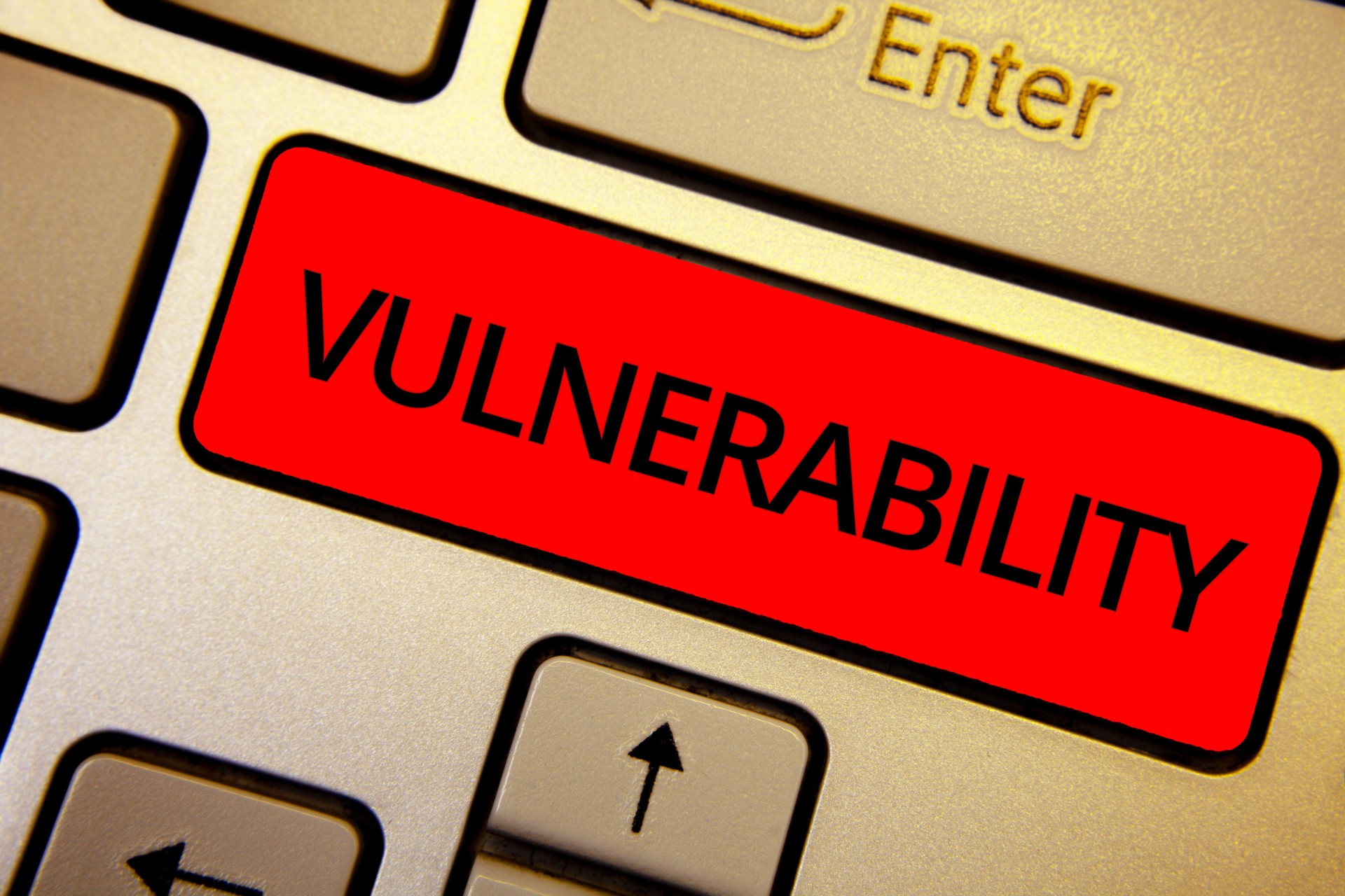 Text sign showing Vulnerability. Conceptual photo Information susceptibility systems bug exploitation attacker Keyboard brown keys yellow laptop idea create computer keypad laptop.